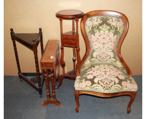 A nursing chair, a mahogany stand, a drop leaf tea table and an umbrella stand.