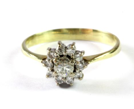 A yellow metal (tested minimum 9ct gold) diamond set cluster ring, (P).