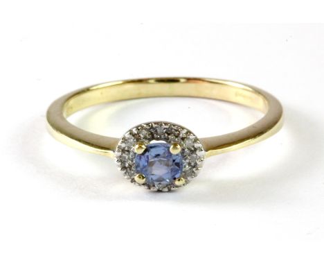 A 9ct yellow gold natural untreated Ceylon sapphire and diamond set halo ring, (M.5).