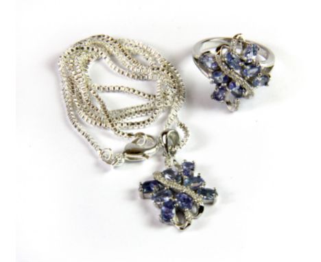 A suite of matching 925 silver tanzanite and white stone set pendant and chain and ring, (I.5).