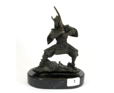 A bronze figure of a Samurai warrior on a black marble base after Kermiko, H. 20cm.