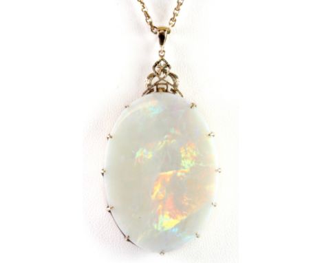 A yellow metal (tested minimum 9ct gold) pendant and chain set with a large flat cut opal, 4.4 x 3.2cm.