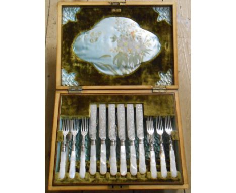 An early 20th Century walnut cased part set of silver plated knives and forks with decorative mother-of-pearl handles