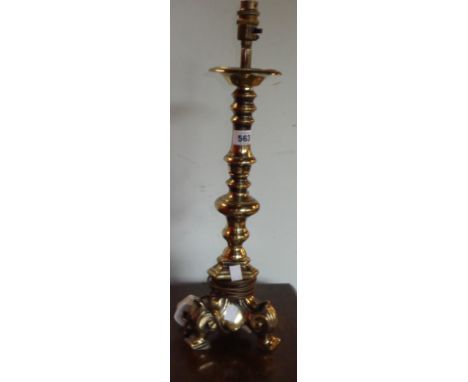 A hollow cast brass table lamp of candlestick form with trefoil foot