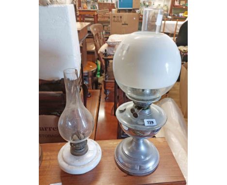 A chrome plated oil lamp with clear glass chimney, double burner and clear and opaque glass shade - sold with a smaller opaqu