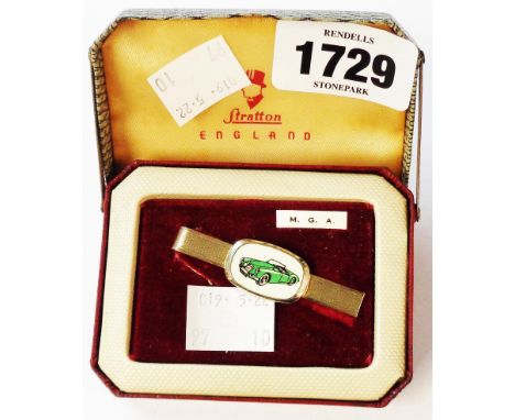 A vintage Stratton tie clip with central panel depicting an M.G.A sports car, in original concertina action box