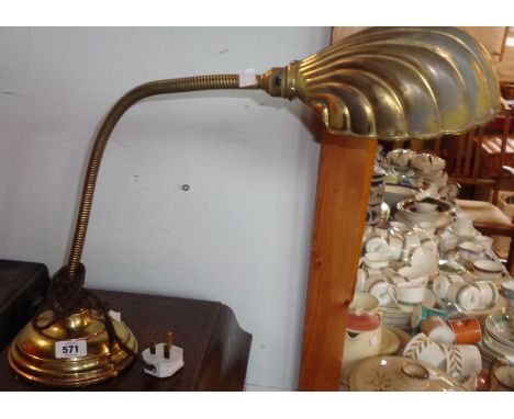 A vintage brass desk lamp with brass clad cast iron base and adjustable swan neck stem with shell shade