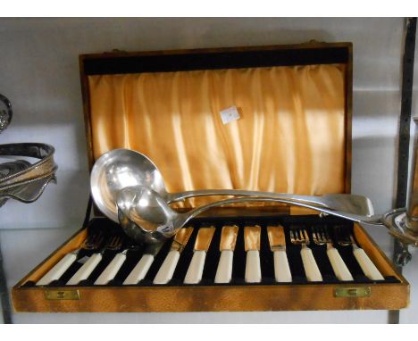 A large EPNS fiddle pattern soup ladle with initial to terminal, another large ladle and a cased set of fish knives and forks