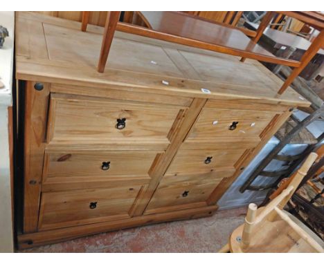 A 1.33m modern pine chest with two flights of three short drawers, set on bracket base