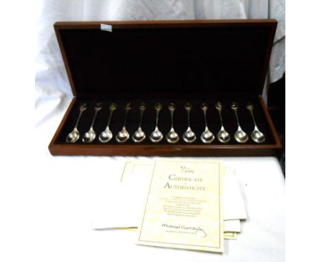 A polished wood cased set of twelve RSPB commemorative silver teaspoons, each with gold plated terminal panel depicting a dif