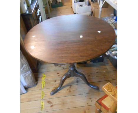 A 74cm diameter 19th Century oak tilt-top pedestal table, set on turned pillar and tripod base