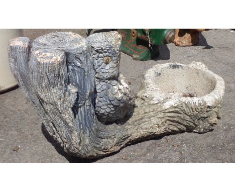 A small concrete figural planter depicting an owl perched upon a fallen tree trunk