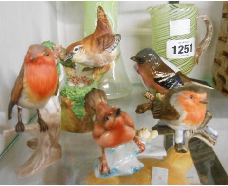 A selection of ceramic bird figurines comprising Crown Staffordshire wren, two Goebel robins, Beswick chaffinch and another