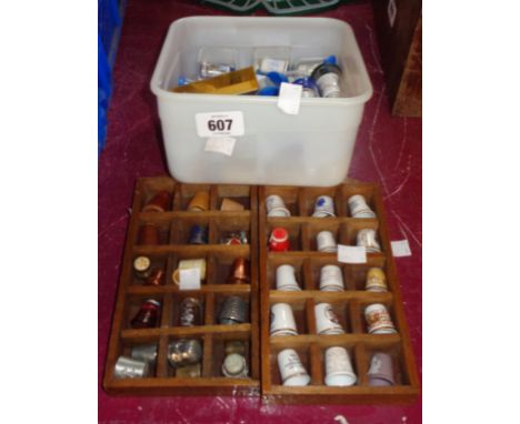 Two small display cases containing a quantity of ceramic and other thimbles including Caithness glass, Caverswall, etc. - sol