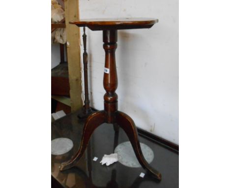 A stained mixed wood tilt-top pedestal table, set on tripod base - adapted