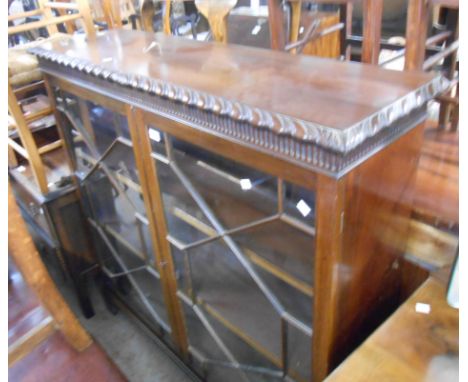 A 1.22m antique style mahogany book cabinet with gadrooned edge and adjustable shelves enclosed by a pair of astragal glazed 