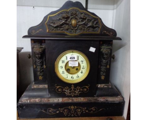 A late Victorian large ornate black slate and marble cased mantel clock with cast metal frieze and flanking caryatids, with J