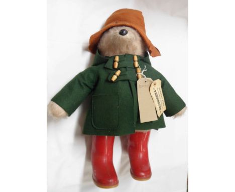 A 1970's Gabriel Designs Paddington Bear soft toy with green felt duffle coat, brown hat, red Dunlop wellies and original pap