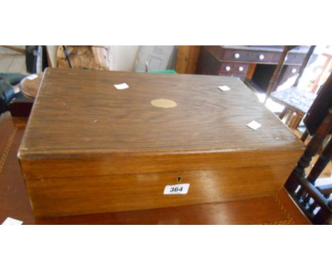 An old stained oak cutlery canteen with tray fitted interior and bearing label for Harrison Bros &amp; Howson, Sheffield