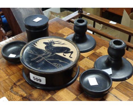 An ebonised wood trinket box with carved stag decoration to lid, a pair of similar ebonised candlesticks and three items of e