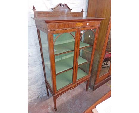 A 93cm Edwardian inlaid mahogany display cabinet with material lined shelves enclosed by a pair of beaded glazed panel doors,