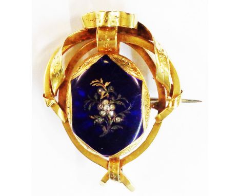 A 5cm Victorian ornate yellow metal brooch with central blue enamel and rose diamond set decoration - slight damage to enamel