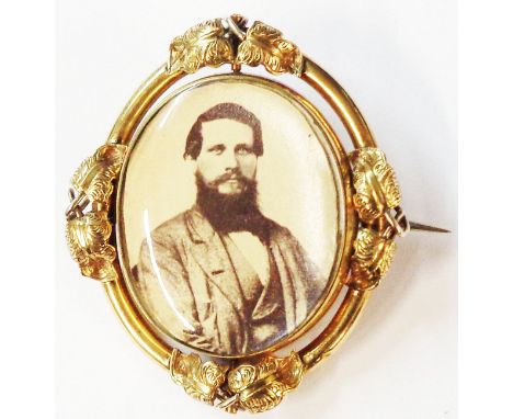 A 5.2cm Victorian gilt metal oval swivel brooch with photographic portrait and plaited hair panel verso
