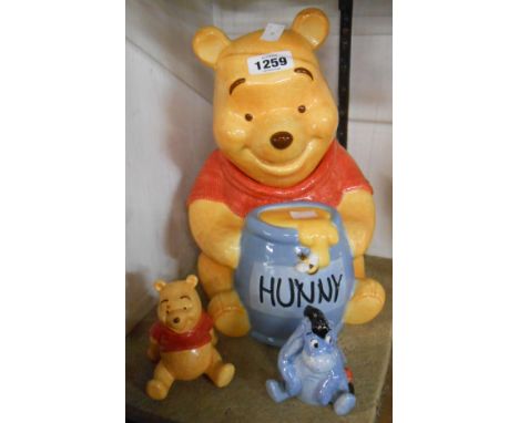 A Simply Pooh ceramic biscuit barrel in the form of Winnie the Pooh holding a honey pot - sold with a similar cruet depicting