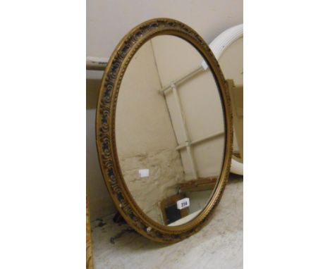 A vintage gilt framed oval mirror with adapted easel back