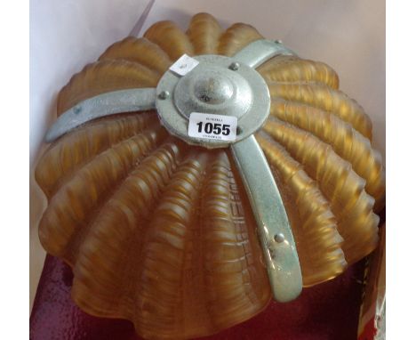 An Art Deco hanging ceiling light with three moulded amber glass shell form shades and a decorative chrome plated bracket cag
