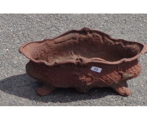 An antique French cast iron planter of classical footed form