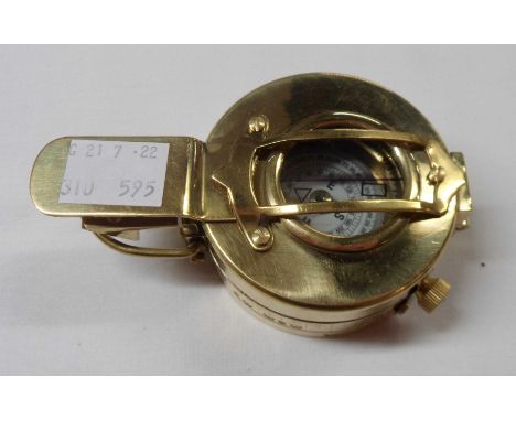 A modern reproduction brass military style compass