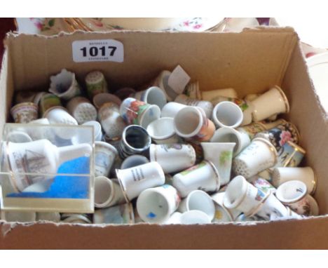 A box containing a large quantity of collectable ceramic and other thimbles including Sutherland china, Poole, Limoges, silve