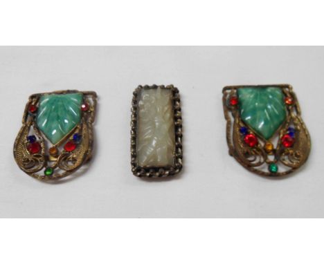 A vintage Chinese carved jade brooch with white metal mount - sold with a vintage filigree metal buckle with inset jade panel