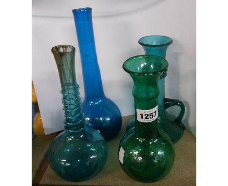 Four soda glass vases of elongated flask form