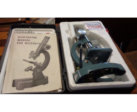 A vintage cased student's microscope kit - sold with an adjustable swan neck table magnifying glass with cast iron base