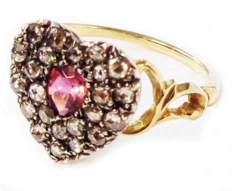 An unmarked yellow metal ring with heart shaped old cut diamond cluster panel, with central oval ruby - size O 1/2 - boxed