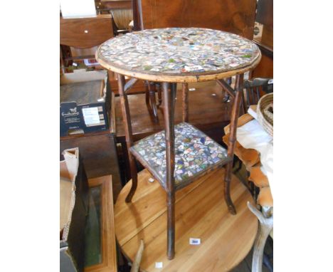 A 45cm diameter antique bamboo two tier occasional table with later ceramic mosaic to surfaces