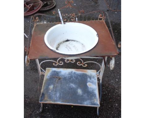 An old metal two tier washstand with enamel wash bowl