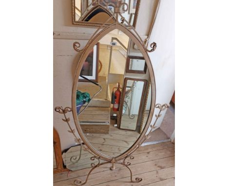 A 1.86m high modern painted wrought iron framed decorative dressing mirror with elliptical plate and applied foliate decorati