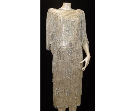 A well made heavy beaded cream silk/rayon flapper dress with silver sequins complete with head-band. Thought to be original 1