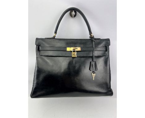 An HERMES Sac à Dépêches (Kelly) bag 35cm. Retourne in black box-calf leather. A top handle handbag bearing a significantly e