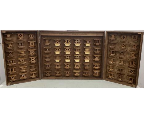 A 1950's Cabinet Containing Sixty-Six Handmade Miniature 'Ceremonial Stools of Ashanti', each intricately carved and bearing 