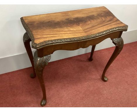 A XX Century Serpentine Shaped Card Table, with fold-over top, on carved cabriole legs and pad feet, 84cm high.