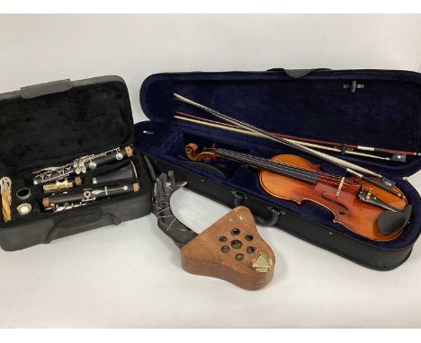 A Modern Kinglos Violin, with neck rest and two bows, in case; A J.P. 121 Mk 3 Clarinet, in case and an African stringed inst