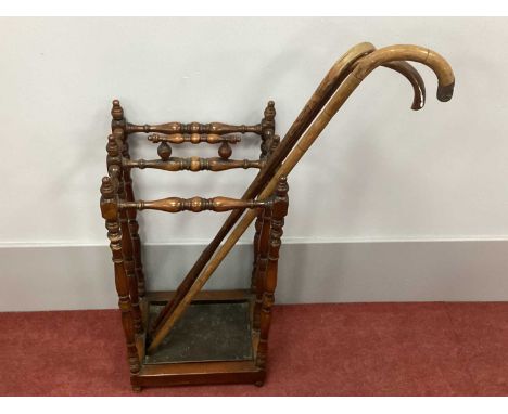 An Early XX Century Mahogany Stick/Umbrella Stand, with a turned carrying handle, turned finials on turned and block supports