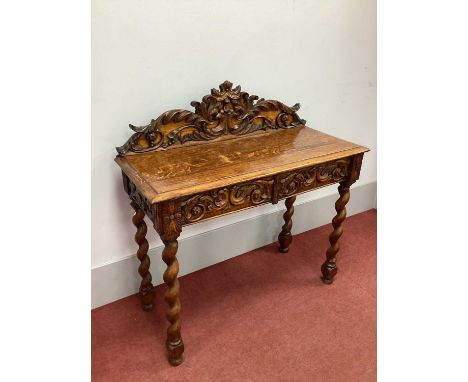 A XIX Century Carved Oak Side Table, with foliate and scroll carving to back, top with moulded edge and two carved drawers, o