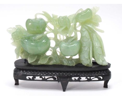 A Mid/Late XX Century Jadeite Carving of a Fruiting Tree, hardwood stand, 16cm high.