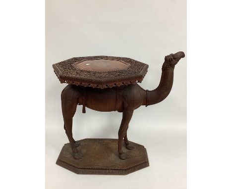 An Anglo India Carved Hardwood Camel Table, circa 1900, the top and base of octagonal form and carved with leaves and flowers