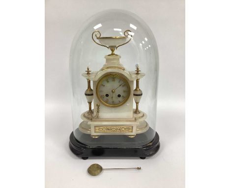 A Late XIX Century French Alabaster and Gilt Metal Mantle Clock, surmounted with a two-handled urn, the shaped base with side